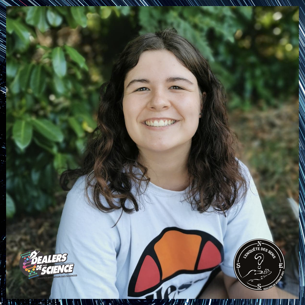 Portrait de Lina, jeune femme souriante avec un t-shirt blanc, assise dans l'herbe 